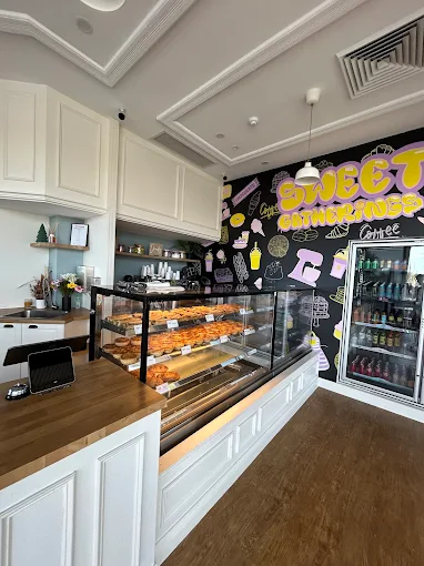 The real Sweet Gatherings shop, with its colourful mural and bakery cabinet